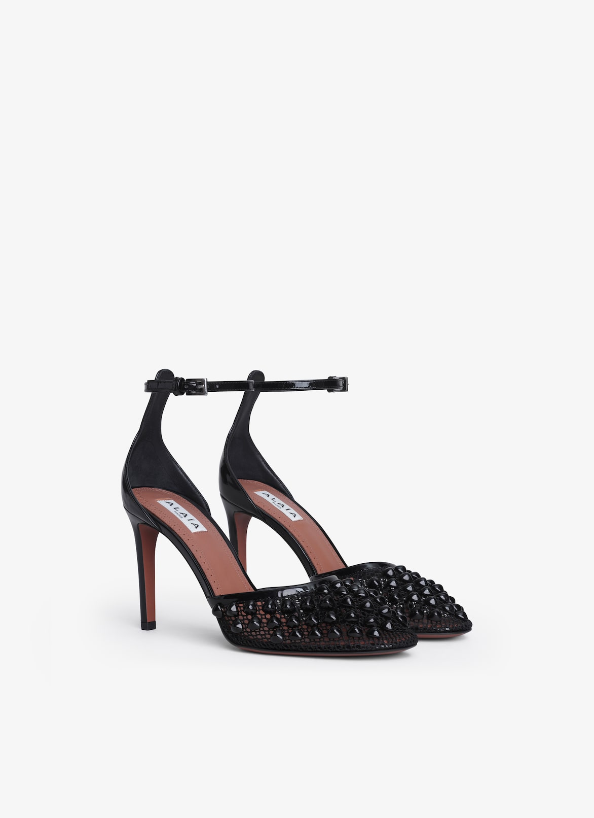 HIGH FISHNET PUMPS WITH STUDS ALAÏA BLACK HIGH FISHNET PUMPS WITH STUDS